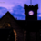 Lerwick Town Hall at dusk, with the clock tower illuminated against a purple and blue sky.