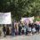 Group of individuals participating in a march with banners promoting recovery from addiction.