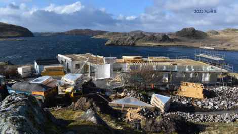 The construction of a house on a rocky island.