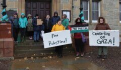 Group of people holding signs advocating for palestine and a ceasefire on gaza.