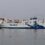 A northlink ferry with a blue and white viking-themed livery sailing on calm waters.