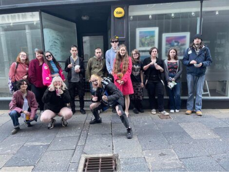 A group of people posing in front of a store.