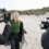 Woman being filmed on a beach for a production.