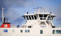 The bridge of a ferry named 'daggalien' with the destination 'lerwick' displayed, against a backdrop of a cloudy sky.