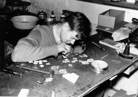 A young man working on a watch.