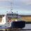 A white and blue boat in the water.