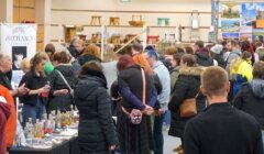 A crowd of people standing in a large room.