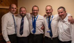 A group of men in ties posing for a photo.