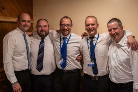 A group of men in ties posing for a photo.