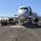 A white airplane is parked on the tarmac.