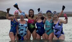 A group of women in swimsuits posing for a picture.