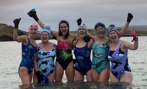 A group of women in swimsuits posing for a picture.