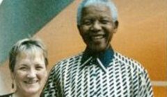 Nelson mandela and a woman posing for a photo.