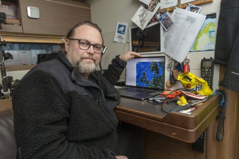 A man sitting at a desk with a laptop.