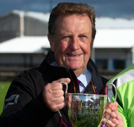 A man holding a trophy.