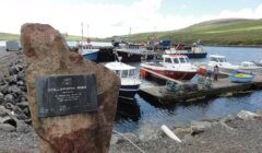 A large rock with a plaque on it.