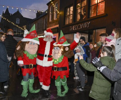 Santa claus dressed as elf.