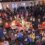 A crowd of people watching a santa claus parade.