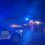 A police car and police cars on a road at night.