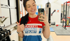 A woman taking a selfie in a gym.