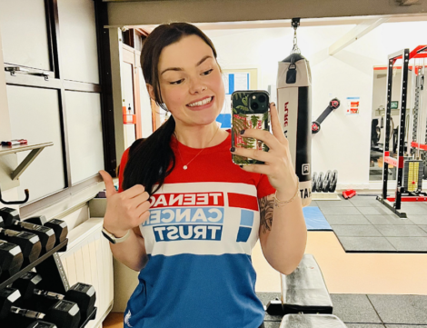 A woman taking a selfie in a gym.