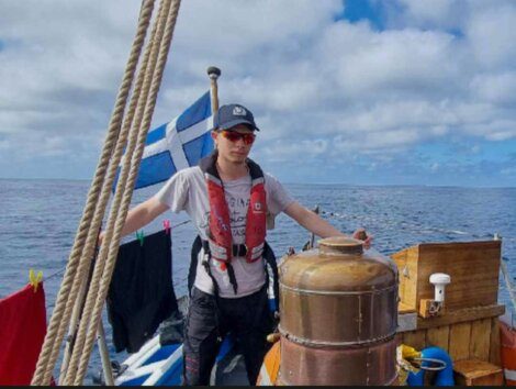 A man standing on the deck of a boat.