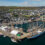 An aerial view of a harbor with boats docked in it.