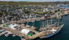 An aerial view of a harbor with boats docked in it.