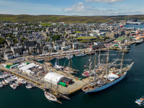 An aerial view of a harbor with boats docked in it.