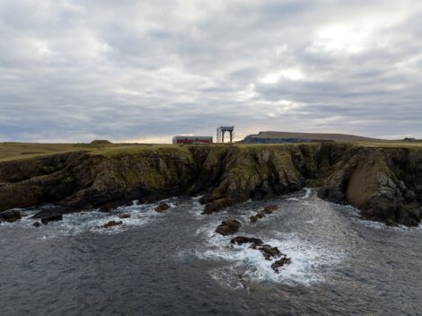 A rocky cliff with a launchpad on it.