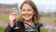 A woman holding a wine glass.