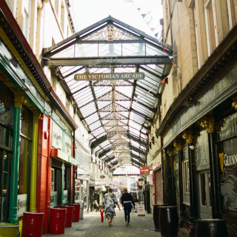 People are walking down a street in a city.