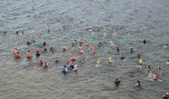 A group of people swimming in the water.