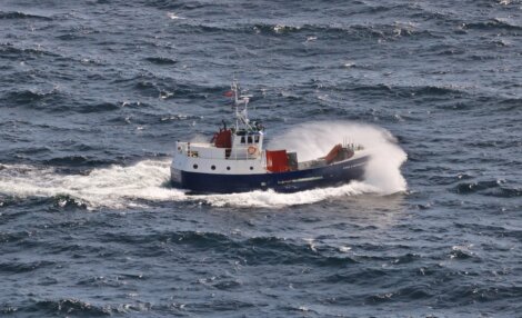 A boat in the middle of the ocean.