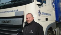 A man standing in front of a truck.