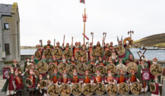 A group of people dressed in viking costumes posing for a photo.