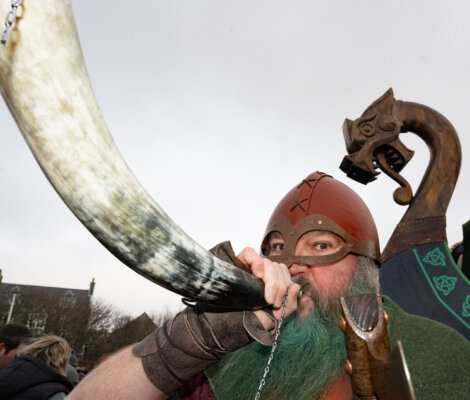 A man drinking from a horn.