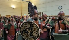 A group of people dressed as vikings in a room.