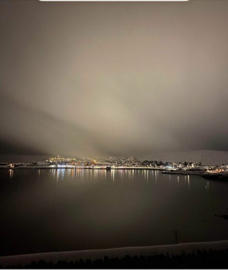 A photo of a city at night with a cloudy sky.