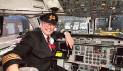 A pilot sitting in the cockpit of an airplane.