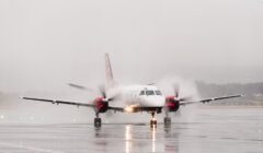 A small plane on a wet runway.