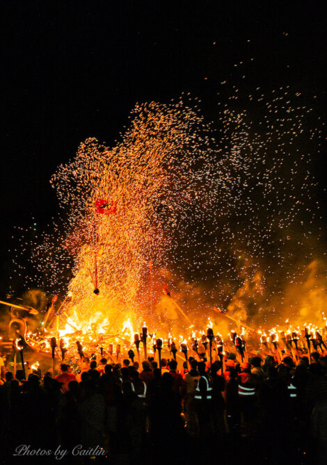 A crowd of people watching a firework display.