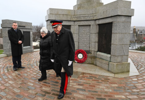 A group of people standing in front of a monument.