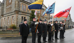 A group of men holding flags.