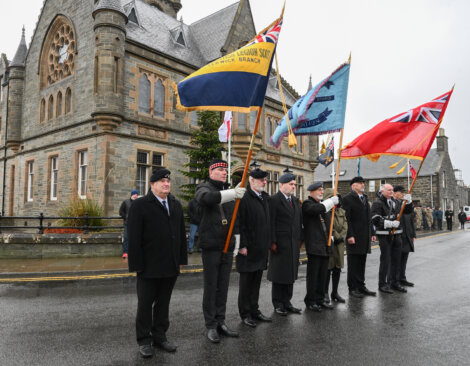 A group of men holding flags.