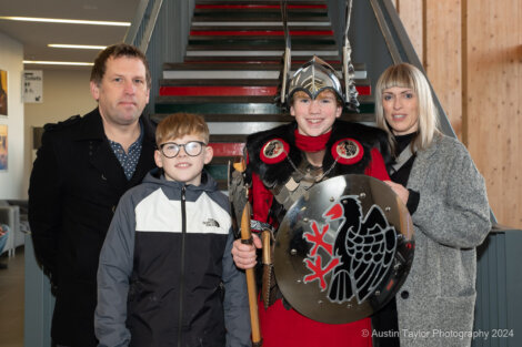 A group of people dressed as vikings pose for a photo.