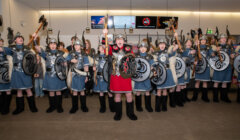 A group of vikings holding shields in an airport.