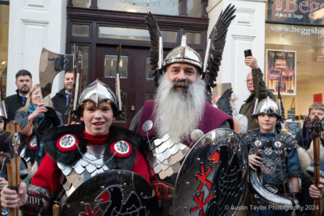 A group of people dressed as vikings pose for a picture.