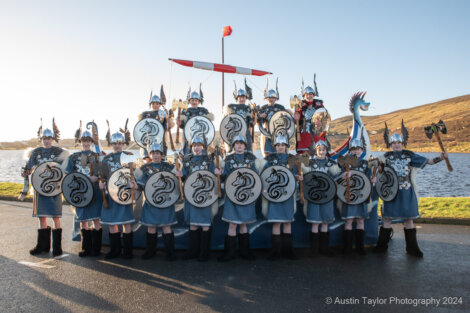 A group of people dressed in viking costumes posing for a photo.