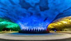 A tunnel is lit up with colorful lights.